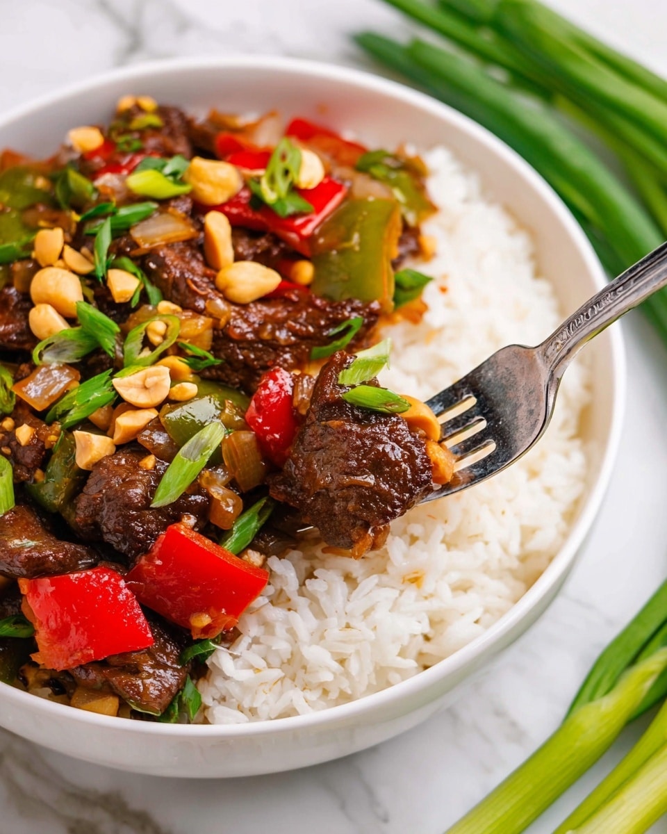 A white bowl filled three layers: the bottom layer is soft white rice with small grains, the middle layer has large pieces of bright red and deep green bell peppers mixed with translucent cooked onion slices, and the top layer shows dark brown slices of beef covered in a shiny sauce, sprinkled with golden peanuts and bright green chopped scallions; a silver fork holds a bite with beef, onion, and green pepper in the center, all placed on a white marbled surface with a bunch of fresh green onions and a full bowl of rice blurred in the background, photo taken with an iphone --ar 4:5 --v 7