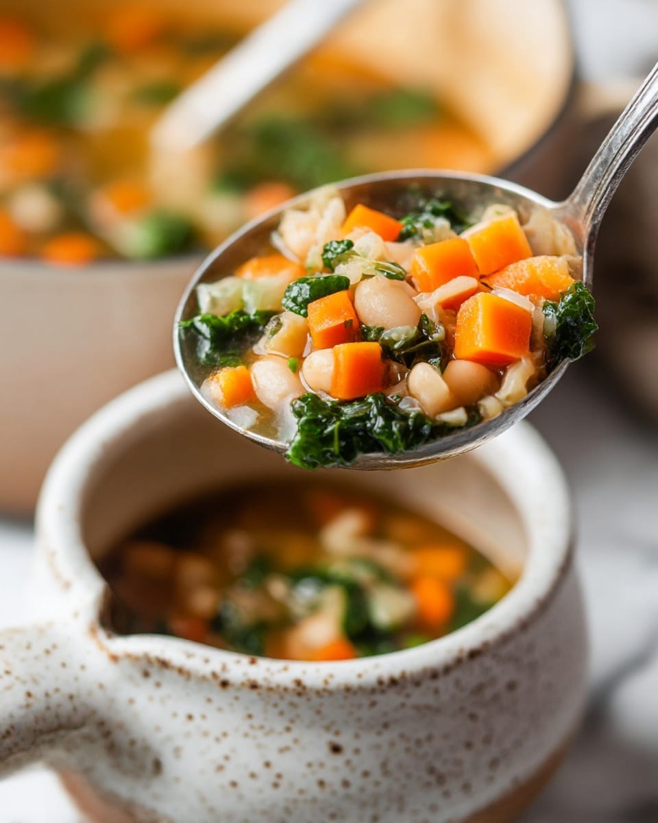 A close-up of a ladle holding a bright vegetable soup with three layers: orange diced carrots on top, white beans in the middle, and dark green kale leaves at the bottom. The ladle is over a white speckled ceramic bowl with a handle, showing the empty inside with light brown hues. The background is softly blurred with more soup visible in a pot, all set on a white marbled surface. The photo taken with an iphone --ar 4:5 --v 7