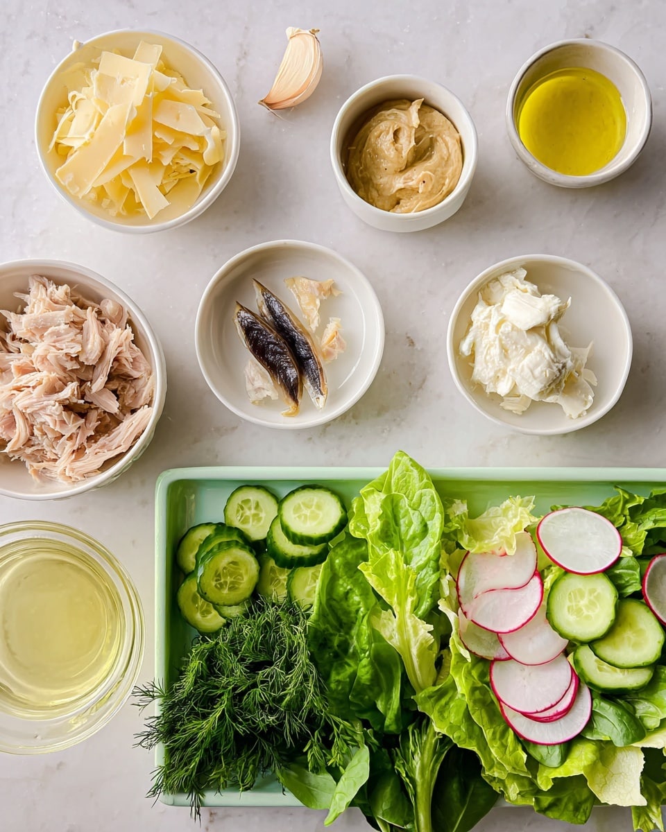 The image shows a top-down view of a preparation scene with small white bowls filled with different ingredients arranged at the top: thin sliced light yellow cheese flakes on the left, shredded white cheese next, a small bowl with mustard-colored sauce, a single garlic clove and dark anchovy fillets, a creamy white dollop likely sour cream or yogurt, shredded light brown cooked chicken pieces, and a glass bowl with light yellow lemon juice. Below these bowls is a pale green tray holding fresh green herbs like parsley, dill, and basil on the left side, and thinly sliced rounds of cucumber and watermelon radish mixed with leafy romaine lettuce on the right. The surface beneath everything is white with a marbled texture. Photo taken with an iphone --ar 4:5 --v 7