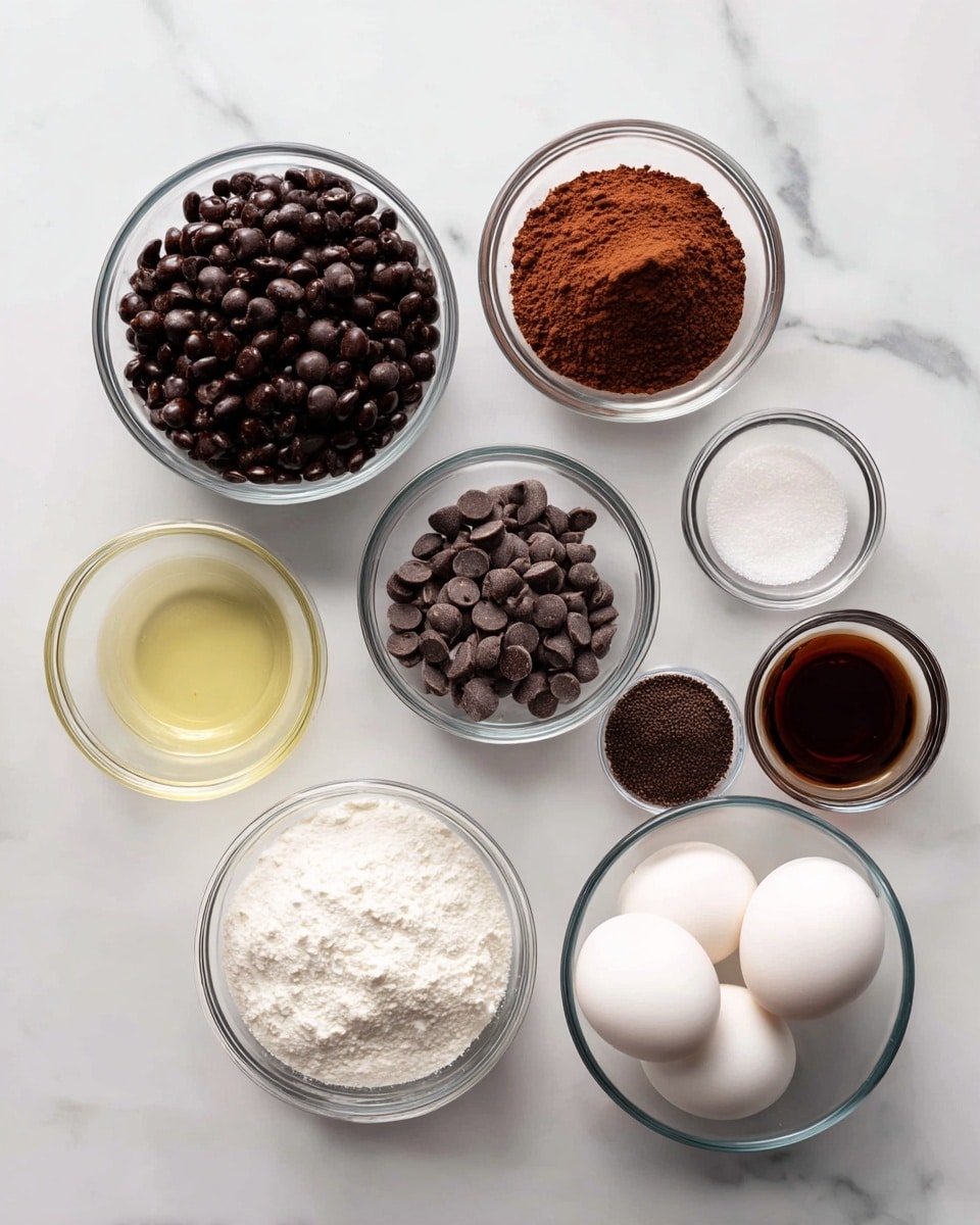 A white marbled surface holds eight glass bowls arranged loosely in a circle, each containing different ingredients. The largest bowl at the upper left is filled with dark black beans. Next to it at the top center, a smaller bowl is full of rich brown cocoa powder. To the right, a tiny bowl contains white salt, and beside it, a medium bowl holds smooth milk chocolate chips with a slightly shiny finish. Below, a tiny bowl contains dark finely ground coffee. Below the coffee, a large bowl is filled with white granulated sugar. To the left, a medium bowl holds a clear, light yellow vegetable oil. Further left, another medium bowl contains three large white eggs. In the center below, a small bowl holds dark brown vanilla extract. The whole setup sits carefully on the white marbled surface, photographed with an iphone --ar 4:5 --v 7